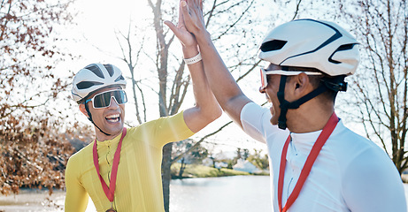 Image showing Cycling men or friends high five for sports winning, marathon travel award and countryside competition or race success. Winner athlete or people in teamwork, triathlon journey goals and support hands