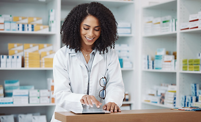 Image showing Pharmacy, medical and pharmacist typing on a tablet searching medicine online, internet and web in a dispensary. Black woman, drugs and healthcare professional in a drugstore for health products