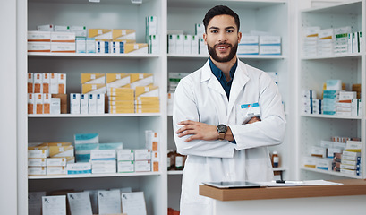 Image showing Pharmacist, man and arms crossed with medicine, portrait and confident with trust, healthcare and happiness. Face, Latino male and employee with smile, pharmacy and wellness in store and happy expert
