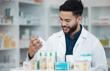 Image showing Pharmacy, medicine and shelf with man in store for healthcare, drugs dispensary and treatment prescription. Medical, pills and shopping with pharmacist for check, label information and product