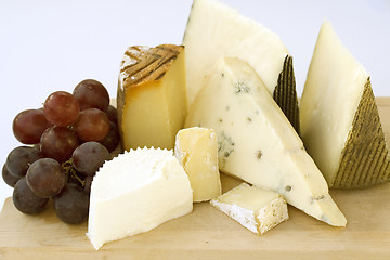 Image showing An assortment of cheeses on a cheese-board