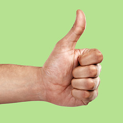 Image showing Hands, thumbs up and like emoji, yes sign or agree gesture against a green studio background. Hand of person showing thumb for success, winning or support for luck, good job or thanks in trust