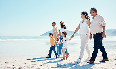 Image showing Beach, walking and mock up with a black family holding hands outdoor in nature by the ocean at sunset together. Nature, love or kids with grandparents, parents and children taking a walk on the coast