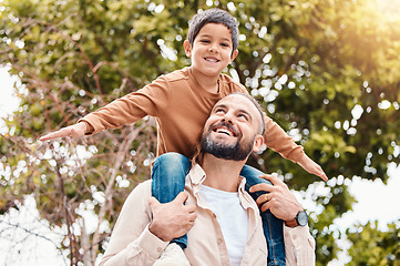 Image showing Father, child and happy back ride in nature for family bonding time, summer break or holiday together outdoors. Happy dad carrying son on piggyback with smile enjoying vacation in the park outside