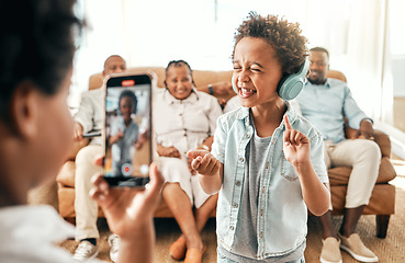 Image showing Filming, phone and music with big family in living room for social media, live streaming and dance. Network, internet and technology with boy and video recording at home for singing, funny and comedy