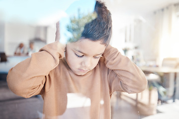 Image showing Sad, home and boy with hands on ears for depression, fear and scared of conflict with family by window. Child psychology, autism and depressed, anxiety and upset kid in living room for mental health