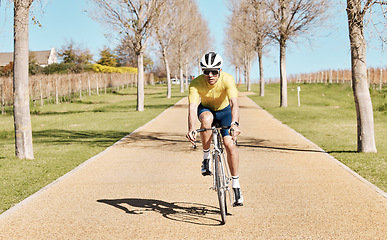 Image showing Cycling, man in bike and fitness outdoor, riding on path in countryside with helmet for safety and workout in park. Action, challenge and cardio with male athlete, training for race or triathlon