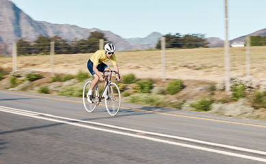 Image showing Cycling, fitness and man with bicycle on road, challenge and action with workout, cyclist outdoor and helmet for safety. Riding, athlete and training for race or triathlon, exercise with bike