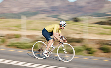 Image showing Cycling, fitness and man with bicycle on road, speed and action, motion blur of cyclist outdoor and helmet for safety. Mockup space, athlete and training for race, exercise in countryside with bike