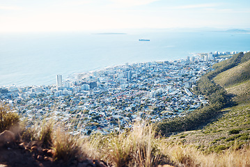 Image showing City, ocean and view with a panoramic landscape of the sea on the coast of an urban town or development. Sky, background or scenic and water around a coastal panorama with buildings and nature