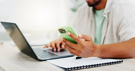 Image showing Phone, laptop and man hands typing while doing research for a freelance project in his living room. Technology, keyboard and male freelancer working online with a computer and cellphone at his home.