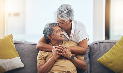 Image showing Love, kiss and senior couple on sofa for bonding, healthy marriage and relationship in living room. Retirement, hug and loving man and woman on couch embrace for trust, commitment and care at home