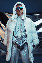 Image showing Holographic, vaporwave and man with fashion and futuristic ski style with sci fi clothing in studio. Art, creative and young male model with trendy, cool sunglasses and cyberpunk designer jacket