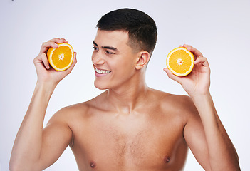 Image showing Beauty, orange and skincare with face of man in studio for health, detox and natural cosmetics. Vitamin c, nutrition and summer with person and fruit on white background for self care and glow