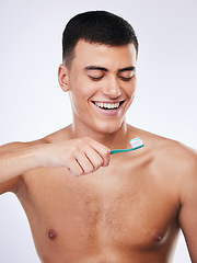 Image showing Happy man, toothbrush and cleaning teeth in dental care hygiene or grooming against a white studio background. Male person smile with toothpaste for tooth whitening, oral or gum and mouth treatment