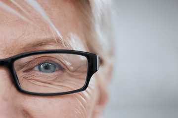 Image showing Eye, old woman and glasses for vision and lens, mockup space and optometry with closeup of health and glaucoma. Prescription eyewear with sight and eyecare, wellness and wrinkles with frame and help