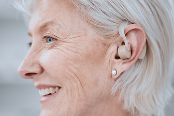 Image showing Senior woman, hearing aid and ear with smile, profile and audio for listening for healthcare in retirement. Elderly lady, deaf or person with disability with technology, sound or implant for wellness