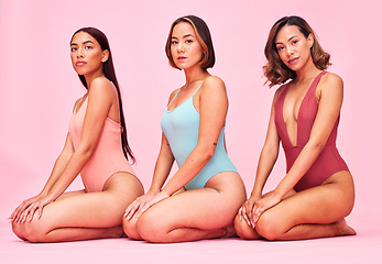 Image showing Beauty, body and portrait of group of women in studio, sitting together with diversity and bikini. Underwear, summer fashion aesthetic and swimwear models with self love, equality and pink background