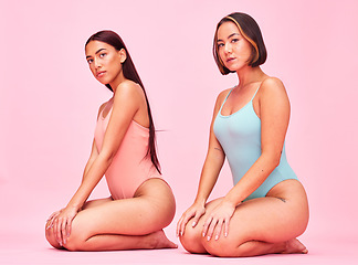 Image showing Diversity, swimwear and portrait of women in studio, sitting together with glow and body positivity swimwear. Beauty, summer fashion and bikini models with self love, equality and pink background.