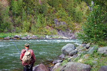 Image showing Fisherman on clean mountain river year daytime