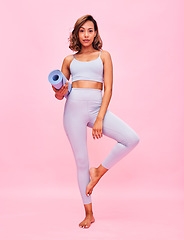 Image showing Yoga, portrait and woman with mat in studio for healthy body, fitness or focus on pink background. Sports model in tree pose for pilates training, holistic workout or balance for exercise performance