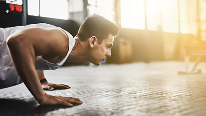 Image showing Fitness, push up and man for training, strong exercise and focus in gym with muscle health on floor. Athlete, bodybuilder or young sports person with shoulder or arm workout and motivation on ground