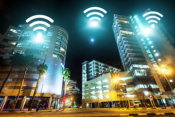Image showing Cityscape, internet and night, wireless connectivity with building, technology abstract and communication online. Location, connection and urban street landscape, cyber and digital transformation