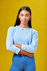 Image showing Arms crossed, fashion and student with portrait of woman in studio for future, pride and serious. Youth, confident and college with Indian person on yellow background for learning and trendy style