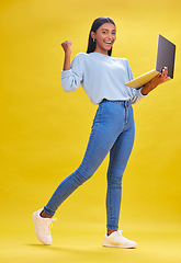 Image showing Woman, student and winner on laptop for success, university news and e learning results or opportunity in studio. Person in college portrait with yes, wow or winning on computer and yellow background