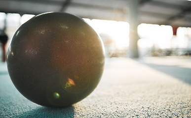 Image showing Gymnastics ball on floor for sports, fitness and lens flare with mockup for exercise, performance or rhythmic dance. Light, ground and aerobics equipment in gym, arena or workout space with sunshine.