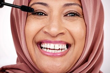 Image showing Portrait, mascara brush and woman in hijab for facial beauty, skincare and cosmetics in studio with smile. Face of happy mature muslim model with eye makeup product, application and tools for lashes.