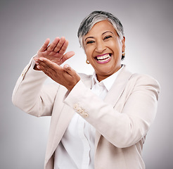 Image showing Happy, money gesture and portrait of woman in studio with cashback, prize or financial freedom. Smile, excited and elderly female model with finance hand sign or emoji for savings by gray background.