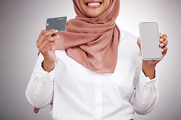 Image showing Woman, hands and credit card with phone screen, fashion e commerce and online shopping mockup in studio. Happy muslim or islamic person with mobile fintech, banking and payment on a white background