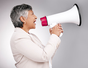 Image showing Business woman, megaphone and protest, voice or news and broadcast or announcement on a white background. Mature person, leader or speaker for noise, call to action and attention or warning in studio