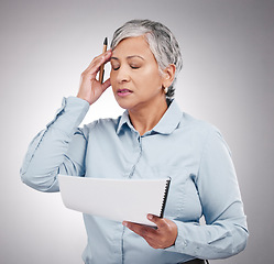 Image showing Business woman, headache and stress for documents, financial paperwork and taxes, audit or debt in studio. Professional manager or mature person in pain or frustrated for budget on a white background