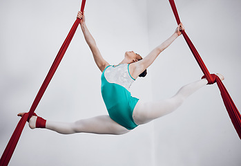 Image showing Gymnast, woman acrobat with performance and sports, fitness and art with athlete on white background. Gymnastics, training and exercise with creativity, talent with fabric and competition in studio