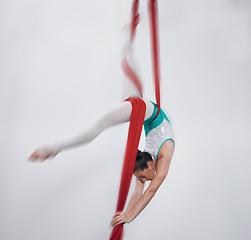 Image showing Gymnastics, performance and woman in sports competition for professional fitness challenge or dancing. Professional, healthy and athlete with balance on silk isolated in a studio white background