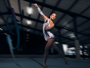 Image showing Fitness, performance and motion blur with a dance woman in a gym for training or practice for a competition. Exercise, event and energy with a young gymnastic or rhythmic dancer in a workout studio