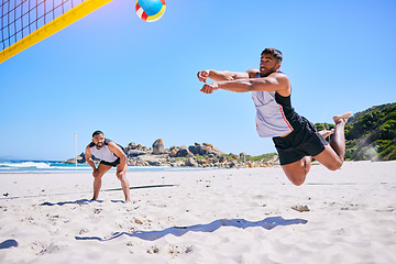 Image showing Man, game and playing volleyball on beach in sports, match or score point in outdoor fitness or exercise. Active male person in teamwork, spike or ball over net in practice or training on ocean coast