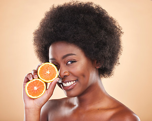 Image showing Orange skincare, portrait and woman on studio background for natural cosmetics, healthy benefits and nutrition. Happy african beauty model with citrus fruits for vitamin c, detox and eco dermatology