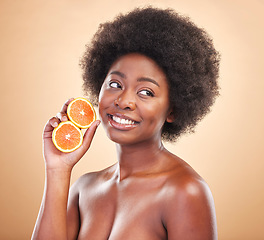 Image showing Orange, natural skincare and woman on studio background for healthy cosmetics, vegan benefits or nutrition. Happy african beauty model thinking of citrus fruits for vitamin c, diet or eco dermatology