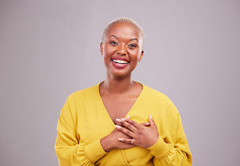 Image showing Thank you, smile and portrait of a black woman in a studio with sweet, happy and positive attitude. Empathy, gratitude and young African female model with grateful gesture isolated by gray background