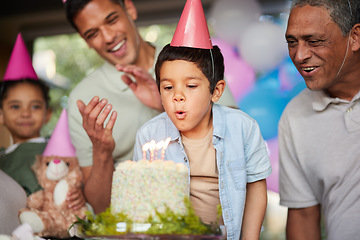 Image showing Boy, birthday party and blow candles with cake, celebration and support with applause, hat and happy in family home. Child, flame and wish with congratulations, food and dessert with gift at event