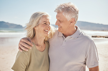 Image showing Senior couple, smile and outdoor at the beach with happiness, freedom and care on vacation. Man and woman on retirement holiday, adventure and romantic trip in nature to relax and travel with love