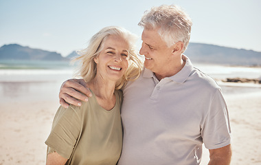 Image showing Hug, senior couple and outdoor at the beach with happiness, freedom and love on vacation. Portrait of a man and woman on retirement holiday, adventure and romantic trip in nature to relax and travel