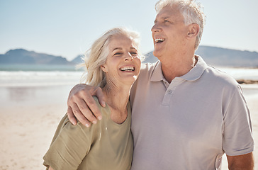 Image showing Senior couple, outdoor and laughing at the beach with happiness, freedom and love on vacation. Funny man and woman on retirement holiday, adventure and romantic trip in nature to relax and travel