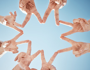 Image showing Hands, star and blue sky, support and solidarity with team huddle, community and V sign with connection. Social, goals and mission with group of people outdoor, cooperation and synergy with low angle