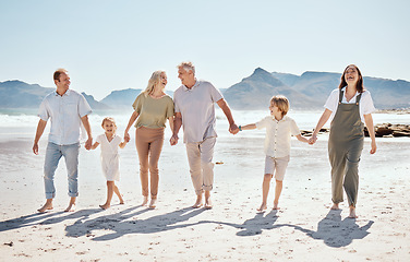 Image showing Family holding hands on beach, generations and adventure with grandparents, parents and kids outdoor. Happiness, travel and sea with love and care, people on holiday with trust and support in nature