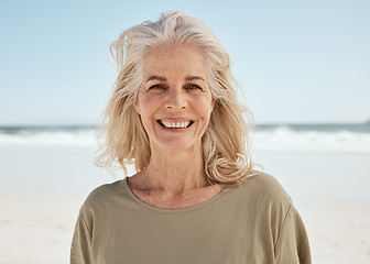 Image showing Portrait, beach and senior woman with a smile, retirement and travel with tourist, summer vacation and wellness. Face, old person and traveler on seaside holiday, Canada and weekend break for peace