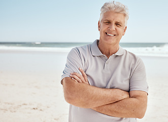 Image showing Beach portrait, arms crossed and senior man relax with summer sunshine, nature freedom or travel holiday in Australia. Morning fresh air, ocean and mature person smile for retirement vacation getaway